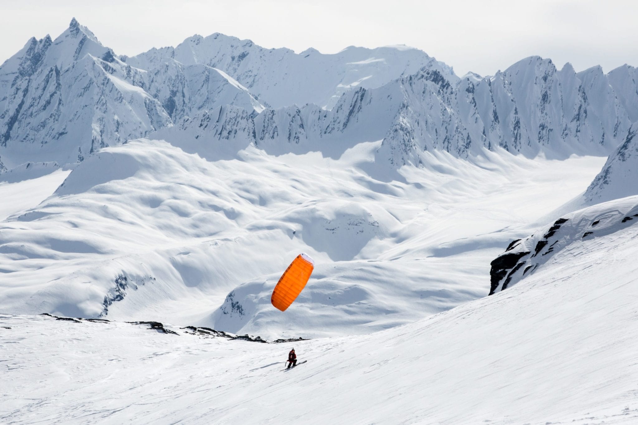 Pascal kiting up a ridge on the Loveland Glacier in preparation of speedflying down.